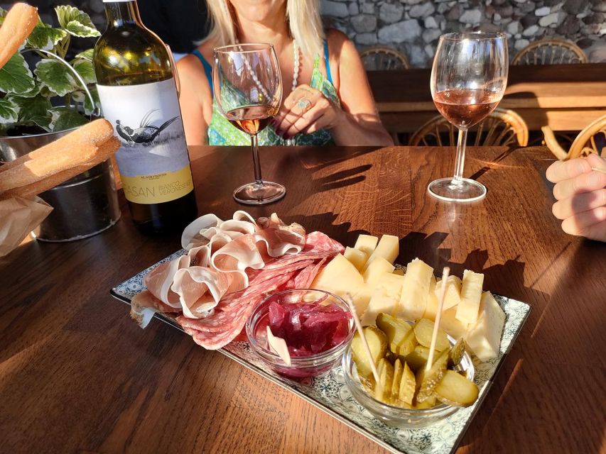 Cavaion: Lake Garda Wine & Food Tasting with Vineyard Tour - Sitting beneath the grape arbor