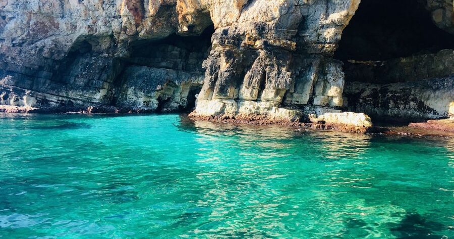 Polignano a Mare: Boat Trip, Swim & Cave with Aperitif - Entering the sea caves along the Adriatic cliffs