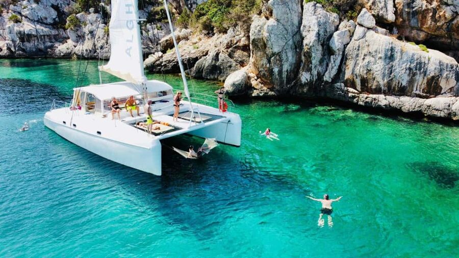 Porto Conte: Half-day catamaran tour with aperitif - Following the coast toward Capo Caccia