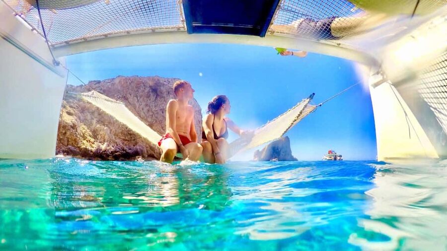Porto Conte: Half-day catamaran tour with aperitif - Cala Dragunara and the swimming break