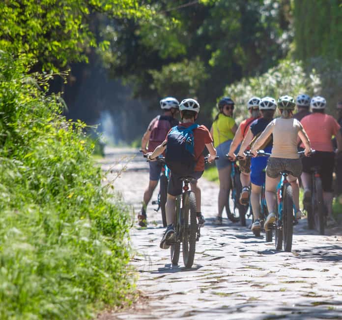 Rome:Appian Way E-bike Tour with Catacombs, Aqueducts & Food - Entering the catacombs beneath the Appian Way