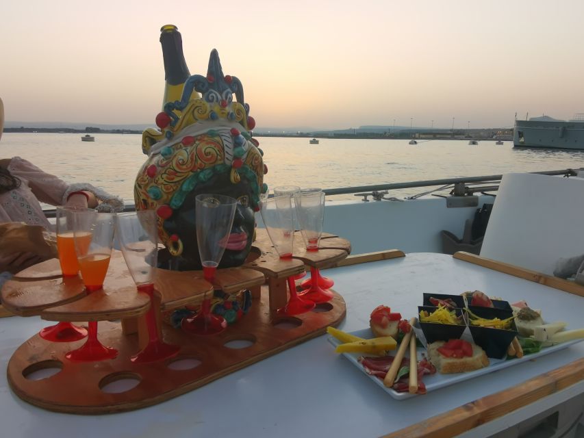 Syracuse: Ortigia Sunset Cruise with Aperitif - Red walls inside the Coral Caves