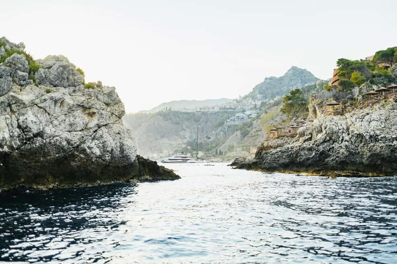 Taormina: Sunset Boat Tour with Dolphin Watching & Aperitif - The caves between Giardini Naxos and Taormina
